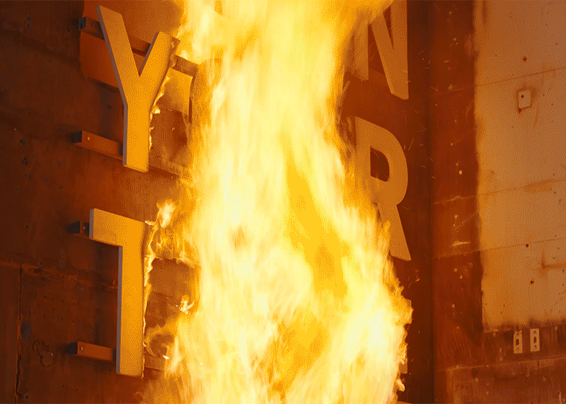 
A gif with a video from a fire test, where large wooden letters with the words 'Don't burn your time' are burned off