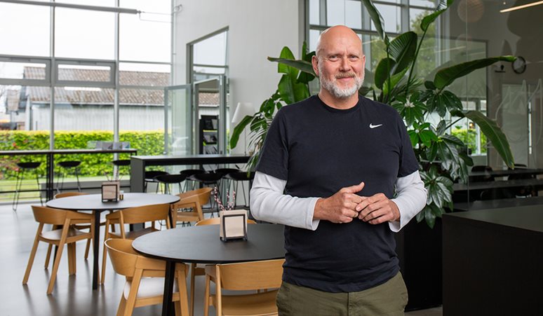 Brian Bak standing in a bright office setting at DBI