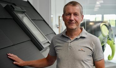 Produkt- og udviklingschef fra Solartag står ved en model af et integreret solcelletag.